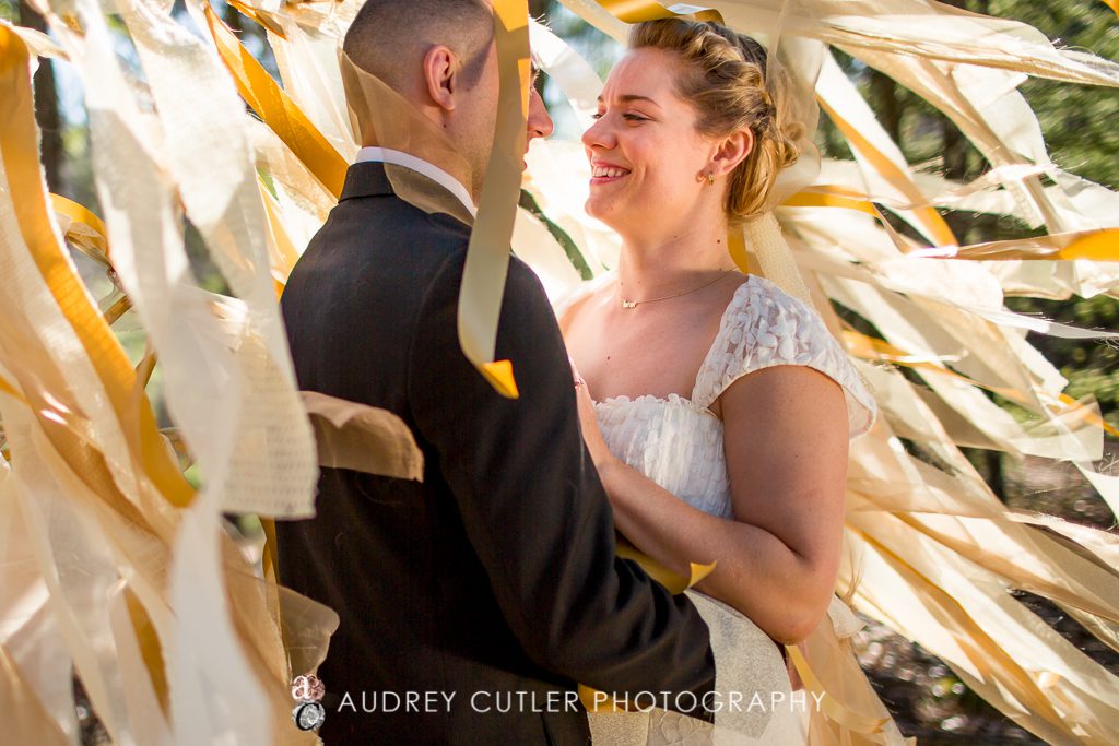 Couple with their DIY gold and yellow vibrant wedding streamers - © Audrey Cutler Photography 2014