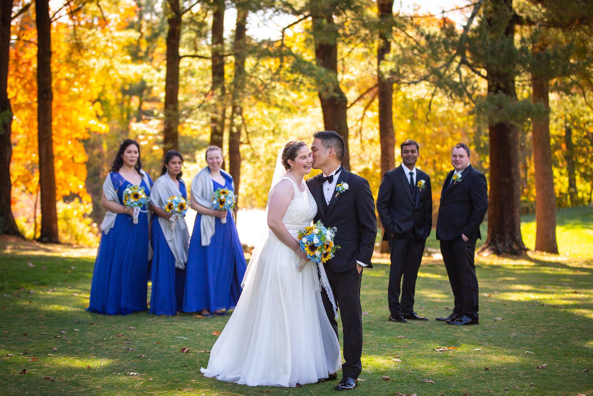 kissing-bride-groom-with-bridal-party-on-fairway-tatnuck-country-club-worcester-ma
