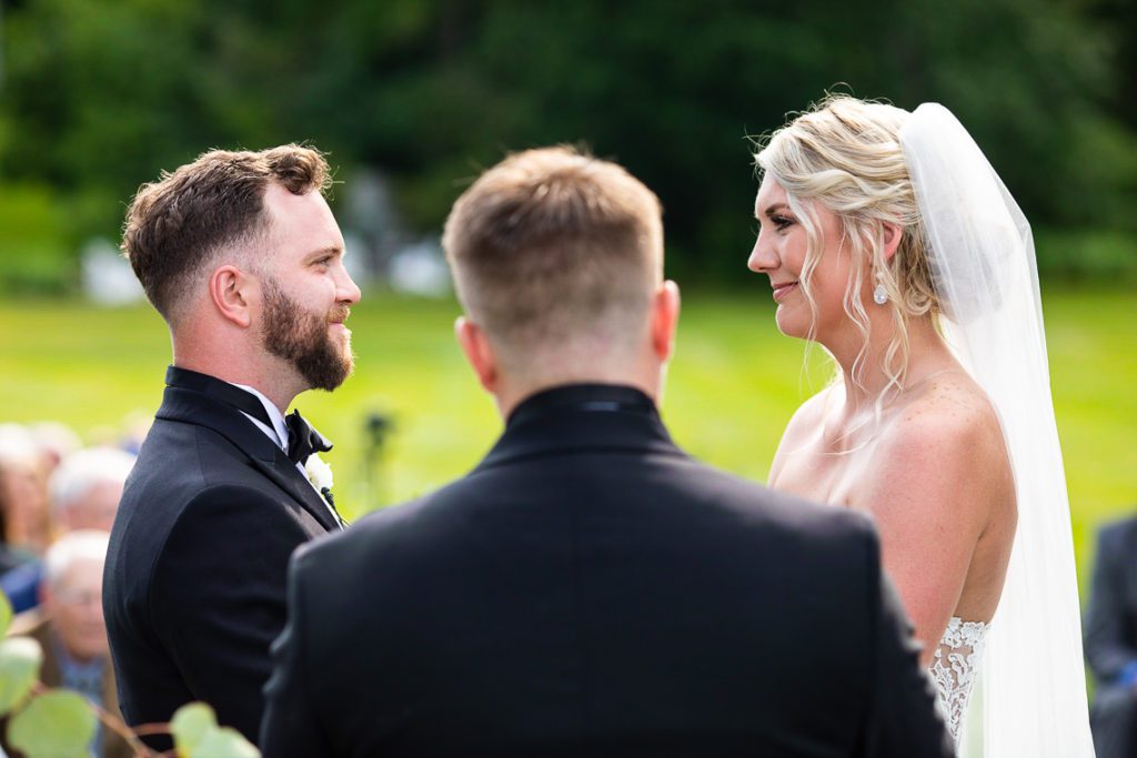 bride-and-groom-smile-at-each-other-during-ceremony-worcester-ma-wedding-photographer-audrey-cutler-photography