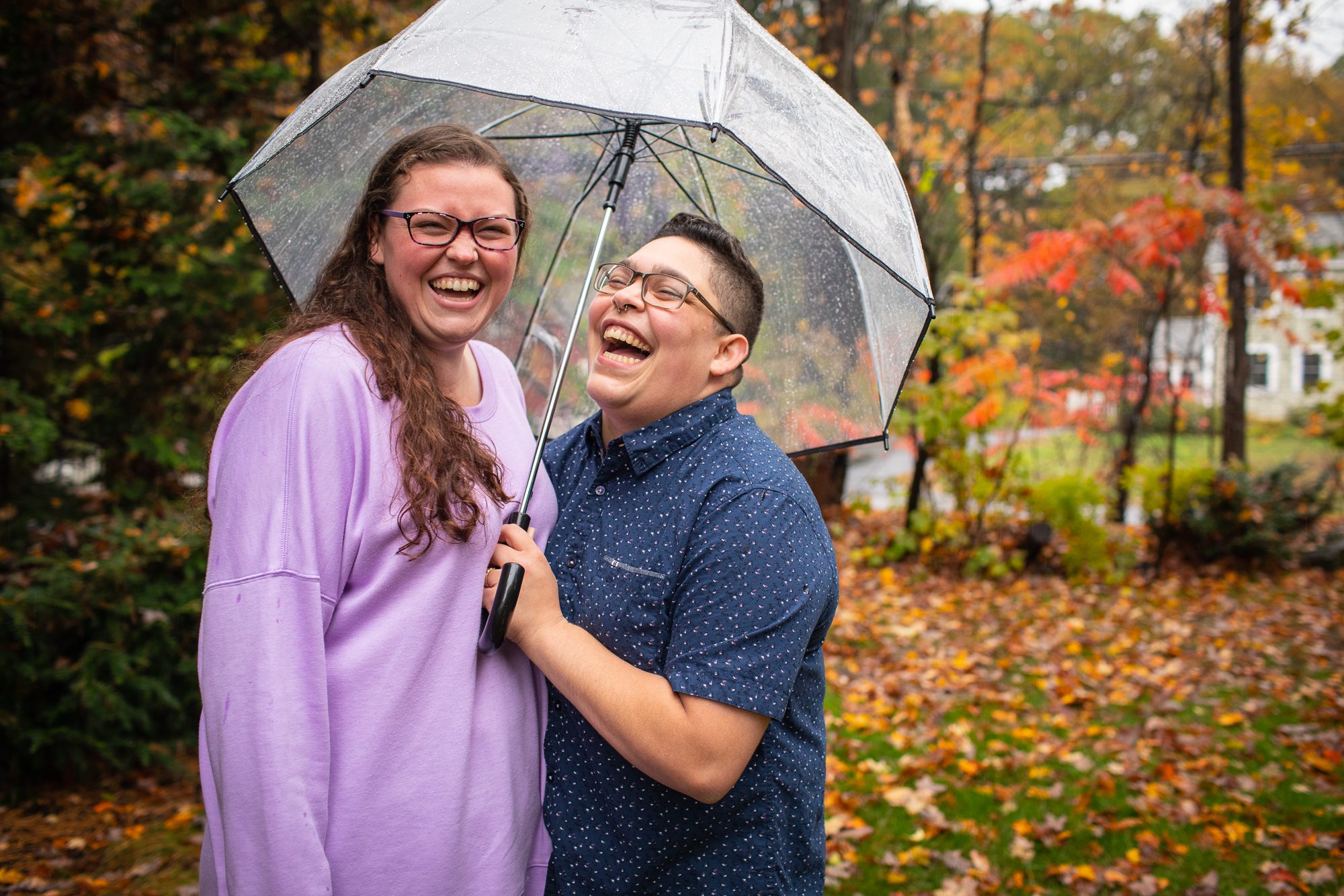 Central MA Engagement Photography Locations same_sex_couple_laughing_in_rain_unbrella_engagement_photos