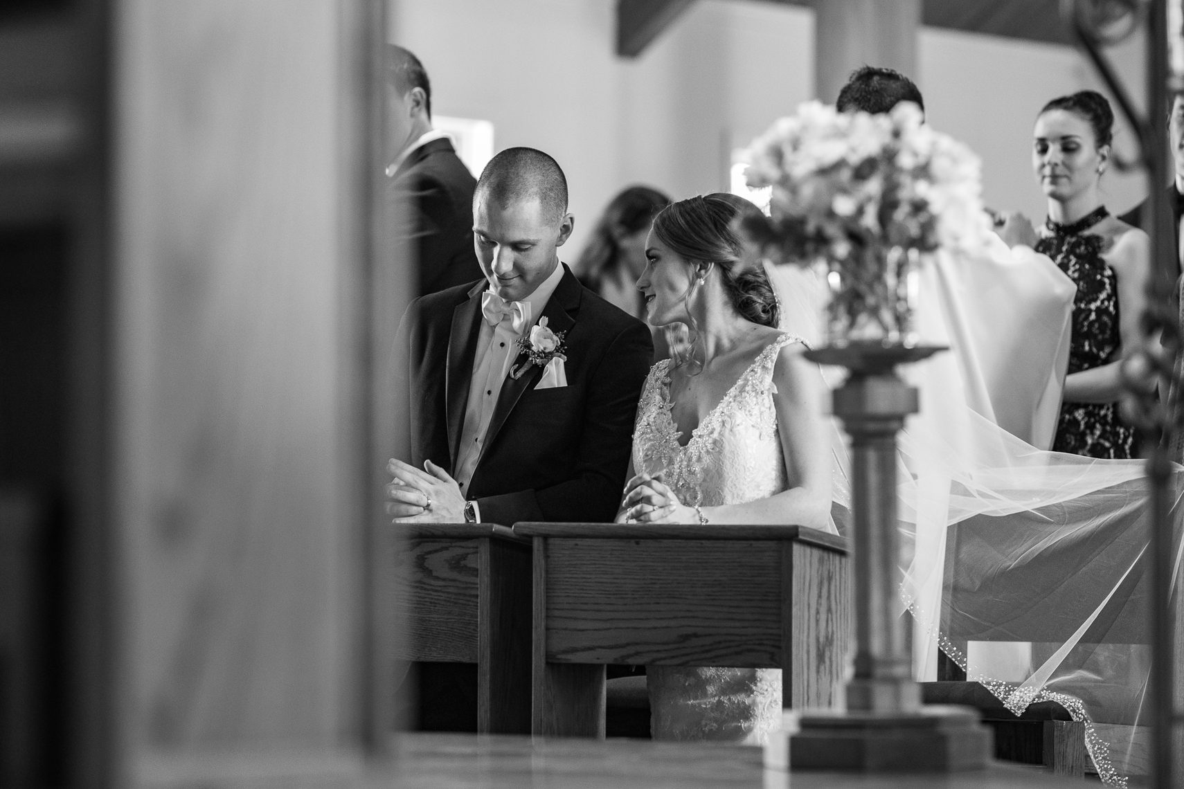 bride-and-groom-whisper-during-church-wedding-ceremony