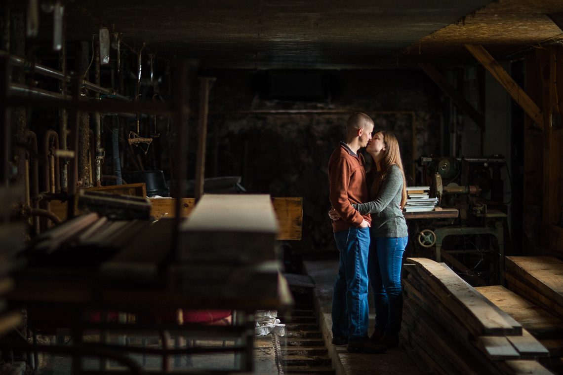 couple-kissing-in-dark-barn-central-ma-engagement-photography-locations-ideas
