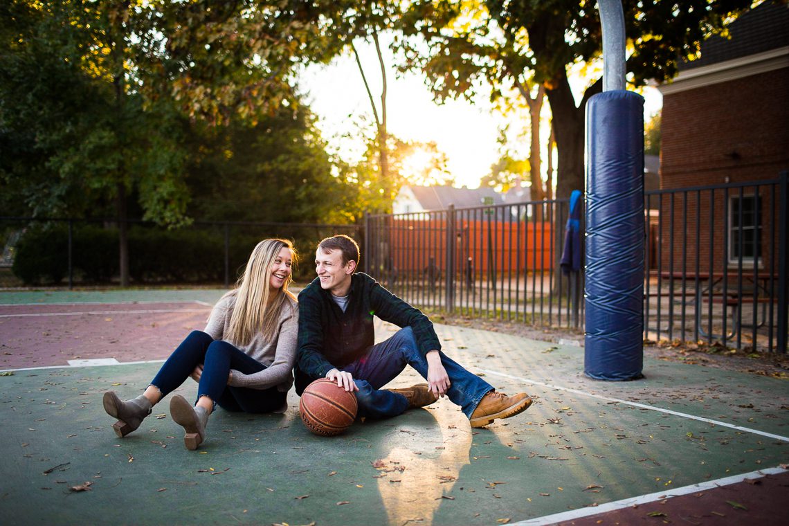 couple-sitting-on-basketball-court-at-sunset-engagement-photo-idea-ma