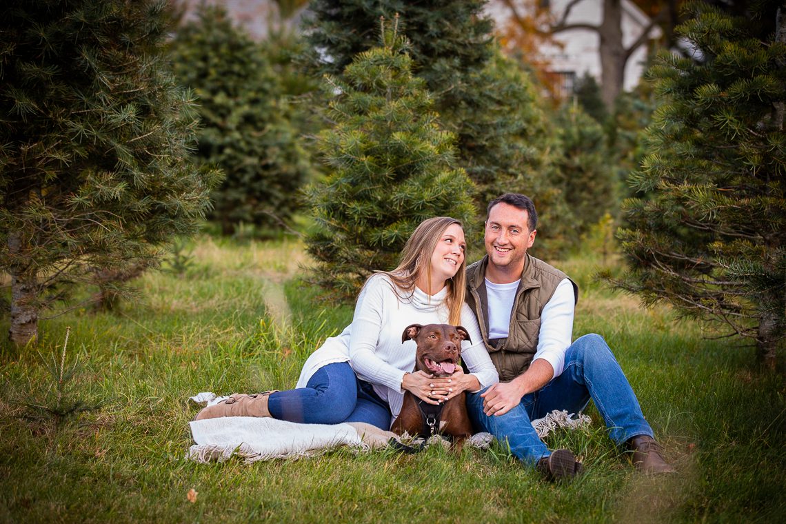 couple-with-their-dog-in-front-of-pine-trees-central-ma-engagement-photography-locations-ideas