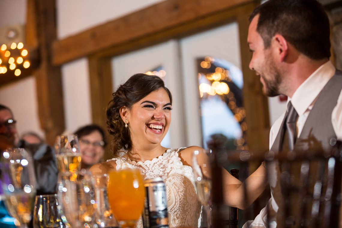 bride-laughing-during-toast-massachusetts-wedding-photographer