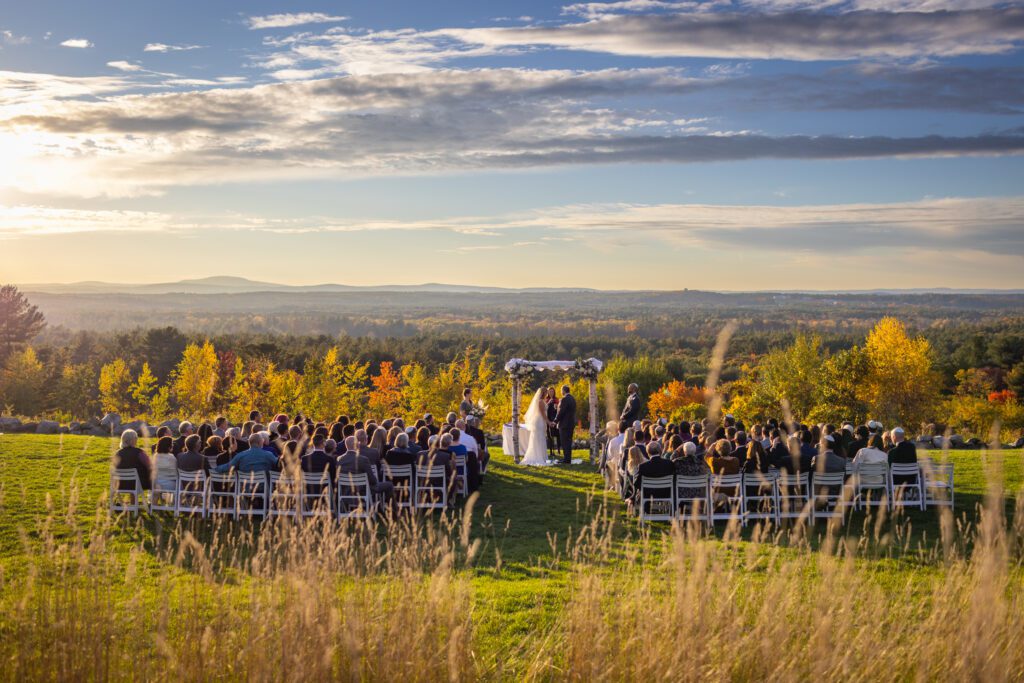 wedding-ceremony-in-field-at-fruitlands-museum-sunset