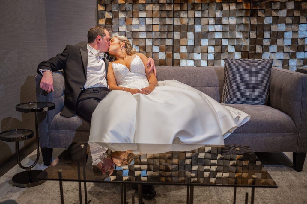 bride-and-groom-kiss-on-couch-in-ac-hotel-marriott-worcester