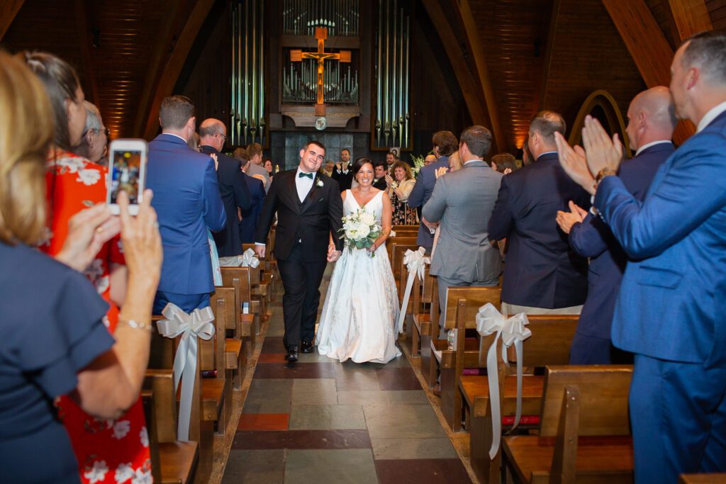 bride-and-groom-walk-down-aisle-chapel-of-the-holy-spirit-wedding-worcester-ma-13