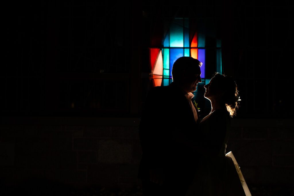 stained-glass-night-photo-of-couple-assumption-college-wedding-worcester-ma-25