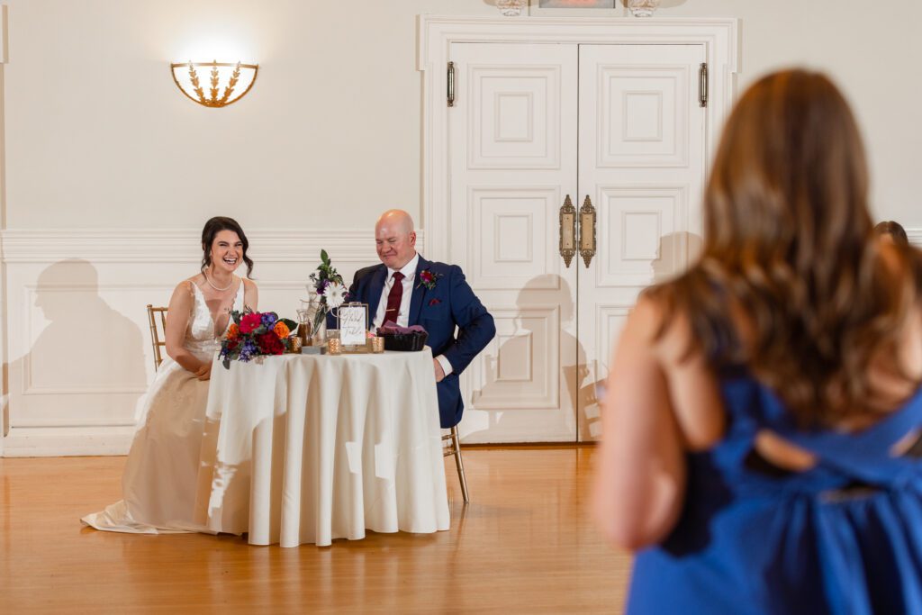 couple-laugh-toasts-worcester-ma-wedding-photographer