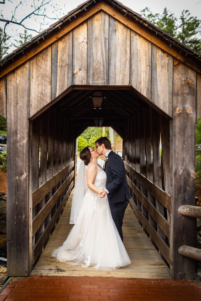 couple-kiss-covered-bridge-the-1761-old-mill-westminster-ma-wedding-