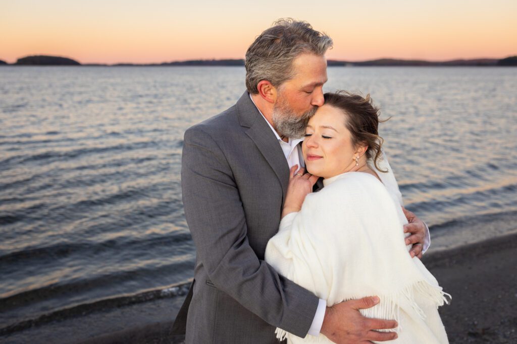 Elopement Photography couple snuggling with water in the background