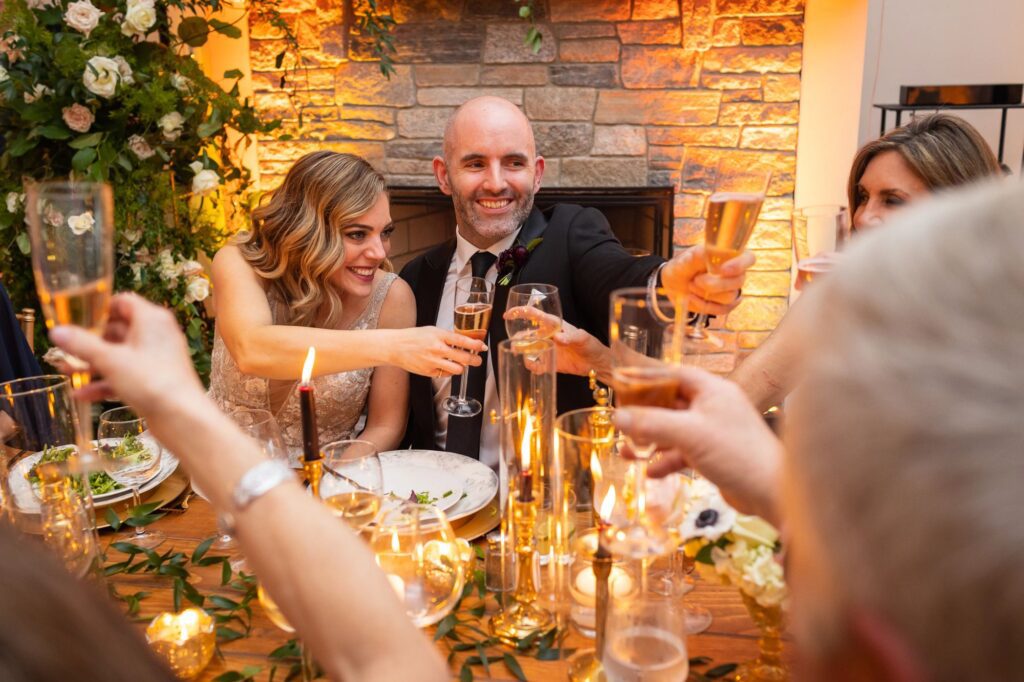 couple-toast-glasses-how-to-have-a-backyard-wedding-at-a-private-residence