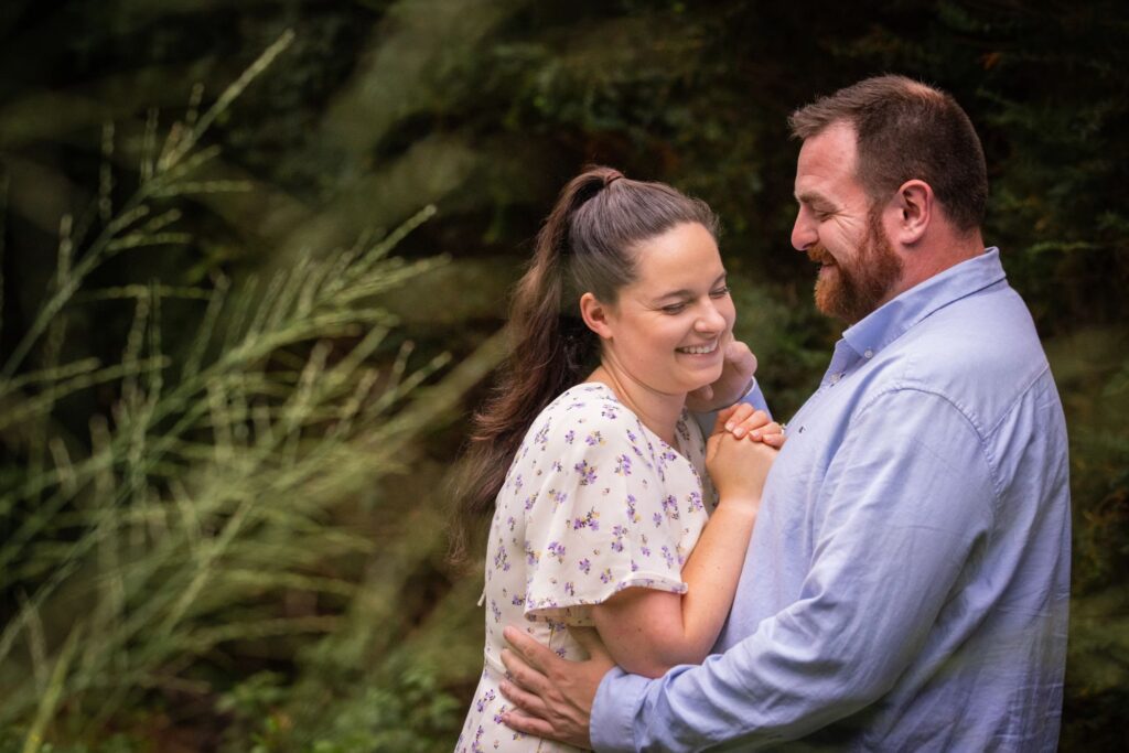 couple embrace and giggle WPI Higgins House Engagement session photos -audrey-cutler-photography